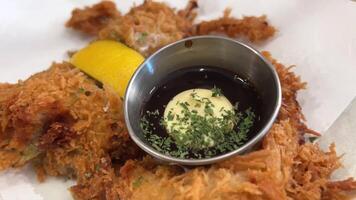 crab in batter with sauce seafood in a restaurant with lemon on a napkin on a plate video