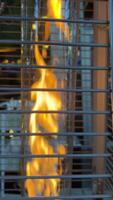 interesting bewitching background fire burning in a flask behind bars with chains against the backdrop of a restaurant place for advertising text attracting attention Eternal flame bask warmly when video