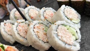 ROLL COMBO, California Roll, Dynamite Roll, Tuna Maki, Salmon Maki slow motion side close up video