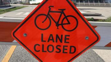 Lane closed sign on the road not allowing bicycles to pass Passage prohibited barrier construction vancouver canada video