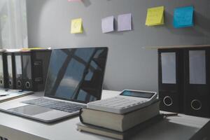 Studio workspace with laptop computer and office supplies. Work from home. With copy space photo