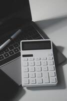 Office leather desk table with calculator and pen. Top view with copy space photo