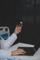 Cropped view of doctor in white coat holding bottle medication, prescribing pills to sick patient via online consultation. Family therapist recommend quality medicines. Healthcare, treatment concept photo