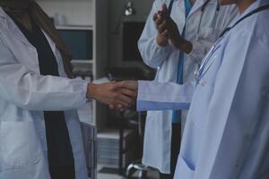 The medical team joins hands and works togetherGroup of scientists joining hands to create experimental works that meet their goals or the success of the trials that have been completed photo