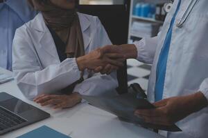 The medical team joins hands and works togetherGroup of scientists joining hands to create experimental works that meet their goals or the success of the trials that have been completed photo