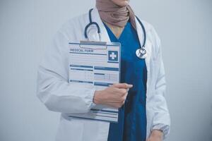 Doctor holding clipboard and stethoscope on background of Hospital ward photo