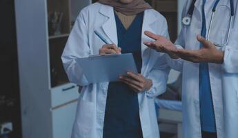 Doctor and patient discussing something while sitting at the table . Medicine and health care concept. Doctor and patient photo