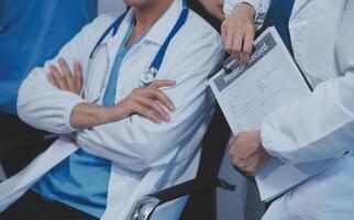 Quality healthcare is all about putting the patient at the centre. Shot of a group of medical practitioners having a discussion in a hospital. photo