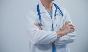 Mature male doctor with tablet pc is giving presentation. Blurred background indoors. photo