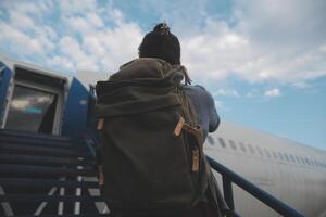 Happy attractive asian woman traveler with backpack at the modern airport terminal, copy space, Tourist journey trip concept photo