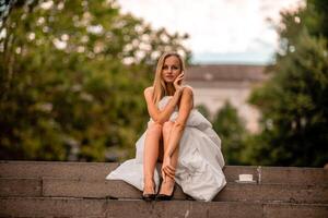 Woman city blanket. Morning in the big city. A blonde woman in a white blanket is enjoying in the city center. Photographed for social media photo