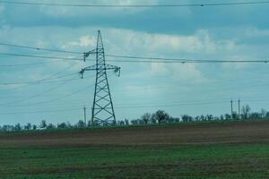 High voltage towers with sky background. Power line support with wires for electricity transmission. High voltage grid tower with wire cable at distribution station. Energy industry, energy saving photo