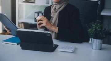 Shot of an attractive mature businesswoman working on laptop in her workstation. photo