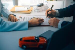 Insurance officers hand over the car keys after the tenant. have signed an auto insurance document or a lease or agreement document Buying or selling a new or used car with a car photo