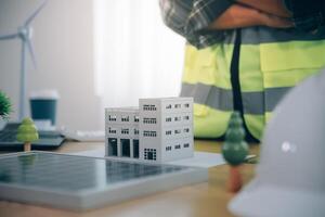 Wind energy engineer designing and developing project for residential district photo