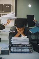 Stressful business man have so many paperwork in the office photo