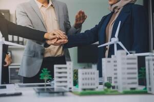 Two business executives, elegantly attired in suits, join hands in a gesture of unity, solidarity, and shared commitment towards a common goal or venture. photo
