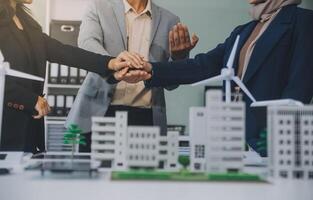 Two business executives, elegantly attired in suits, join hands in a gesture of unity, solidarity, and shared commitment towards a common goal or venture. photo