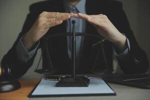 Business and lawyers discussing contract papers with brass scale on desk in office. Law, legal services, advice, justice and law concept picture with film grain effect photo