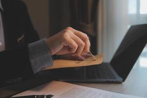 Business and lawyers discussing contract papers with brass scale on desk in office. Law, legal services, advice, justice and law concept picture with film grain effect photo