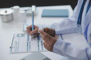 Cropped view of doctor in white coat holding bottle medication, prescribing pills to sick patient via online consultation. Family therapist recommend quality medicines. Healthcare, treatment concept photo