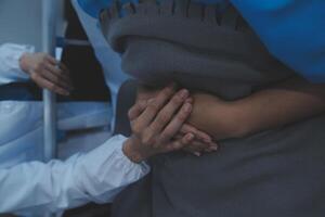 Cropped shot of a female nurse hold her senior patient's hand. Giving Support. Doctor helping old patient with Alzheimer's disease. Female carer holding hands of senior man photo