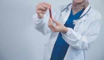 Technician, doctor, scientist in laboratory with blood sample tubes and rack In the laboratory holding a blood vessel sample for study, experiment, medical research biotechnology DNA testing. photo