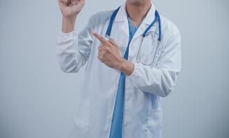 Mature male doctor with tablet pc is giving presentation. Blurred background indoors. photo