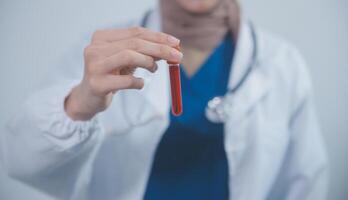 Technician, doctor, scientist in laboratory with blood sample tubes and rack In the laboratory holding a blood vessel sample for study, experiment, medical research biotechnology DNA testing. photo