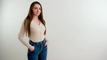 Portrait of a young smiling woman looking at the camera with her arms crossed. A happy girl standing in a creative office. A successful businesswoman standing in an office with copy space. video