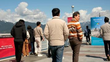 kanada plats asiatisk män gående längs de promenad i de hamn Bra väder par man och gravid kvinna arabs av annorlunda nationaliteter leva i kanada himmel med moln ljus Sol annorlunda tecken video