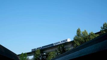 céu trens a partir de inferior acima trem do azul linha passagem contra fundo do céu skytrain ponte dentro Novo Westminster fraser rio rebocador, Novo Westminster Horizonte. uma rebocador viaja acima a fraser rio video