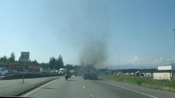 fuming car on the highway waste gas pipe air pollution Life in a big city metropolis drive through the field vancouver canada surrey 2023 video