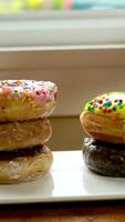 assorted donuts with different fillings and icing. Dolly video