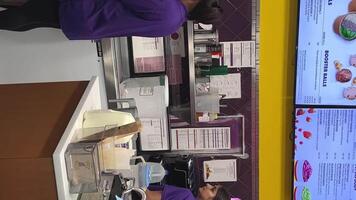 booster juice small kitchen at the bar preparing smoothies workers work as teenagers first job street job cafe busy busy schedule salary money canada 2023 video