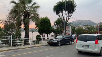 Albania Central street Saranta Embankment cars people tourists life in city of hotels beach of Ionian Sea news real life stories Travelers vacation on beach trip to sea Albania Saranta 09.09.2023 video