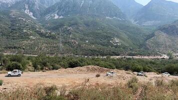 jeep Safari cars driving through the mountains in Albania Albanian Riviera excursions tour travel along the shore of the Ionian Sea trees spring summer video