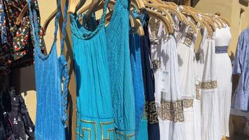 street market selling Greek dresses of different colors on the island of Corfu video