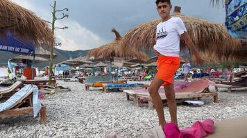strand i de by av borsh i albania klar himmel semesterfirare människor skön hav joniska hav pittoresk strand hyddor längs de albania riviera tidigt i de morgon- under en skön somrar dag video