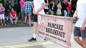 Cloverdale sign pancake breakfast two male teenagers in white T-shirts and shorts carry an advertisement at a gay pride parade video