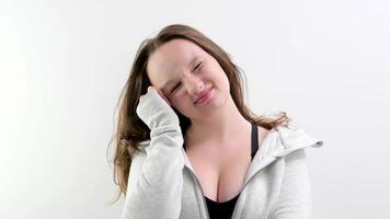 Woman in a black shirt with a direct look of disappointment on a white background video