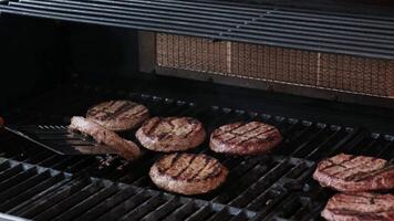 Beef burgers grilling close up BBQ burgers prepared on barbecue fire flame grill with beef meat video