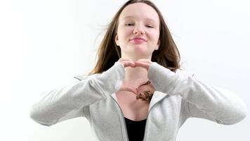 Close up of happy young woman smiling and showing hands sign heart shape looking at camera. Healthy heart health life insurance, love and charity, voluntary social work. video