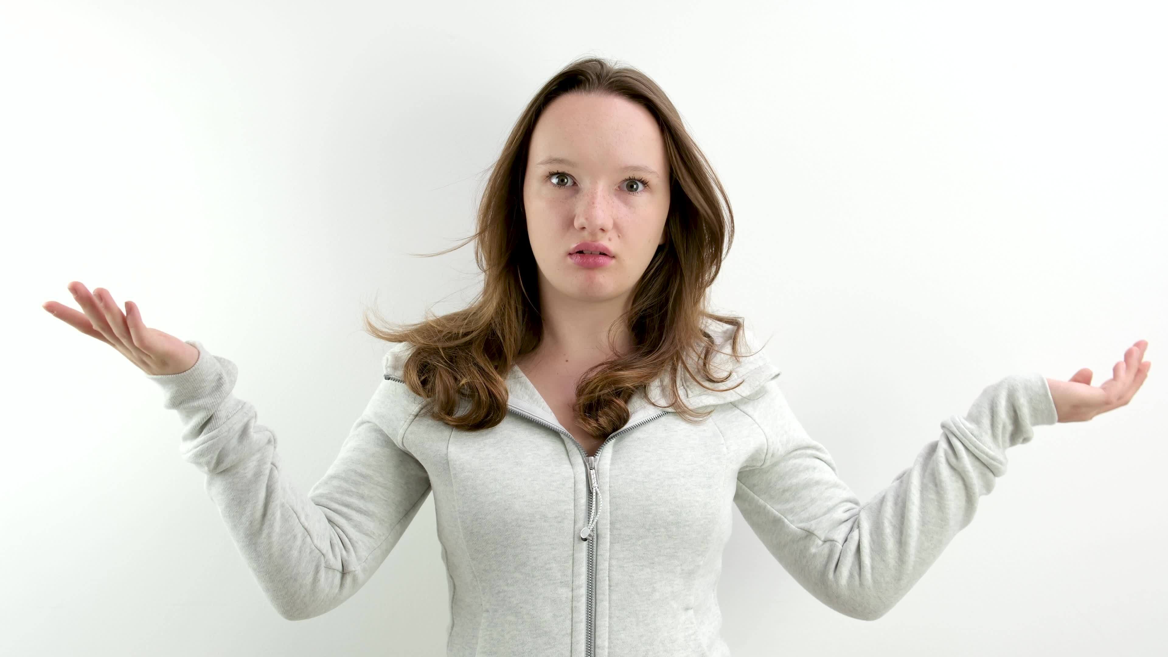 surprise amazement young teenage girl points with her finger to the left on  an empty space for text surprised grabs her head with both hands Could this  be an unpleasant emotion white background