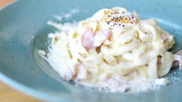 stänga upp av en gaffel tar spaghetti med carbonara sås från en tallrik. varm spaghetti carbonara på en gaffel. italiensk kök och Hem matlagning begrepp video