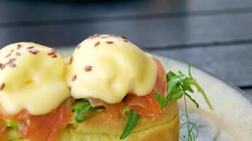 Traditional egg benedict with slices of bacon on toast, poached egg and hollandaise video