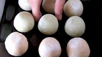mochi ice cream take a bite of dessert and put it back on a black plate with green tea flavor a popular Asian delicacy rice flour video