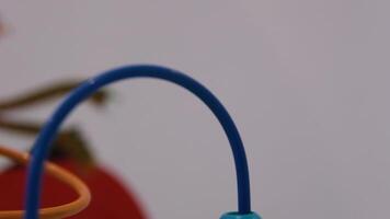 A cute little girl playing with an abacus, learning to count. Front view, detail of the beads being moved. video