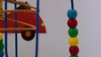 A cute little girl playing with an abacus, learning to count. Front view, detail of the beads being moved. video