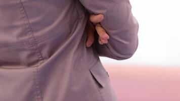 Cross your arms over your chest Close-up of crossed hands of a woman wearing lilac clothes Medical workers clothing posture waiting to talk video